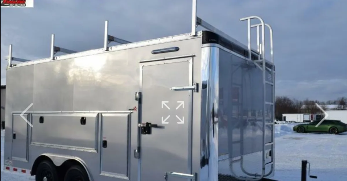 443970_blogbanner A custom contractor trailer sits on the parking lot of a trailer company. The custom trailer is silver.
