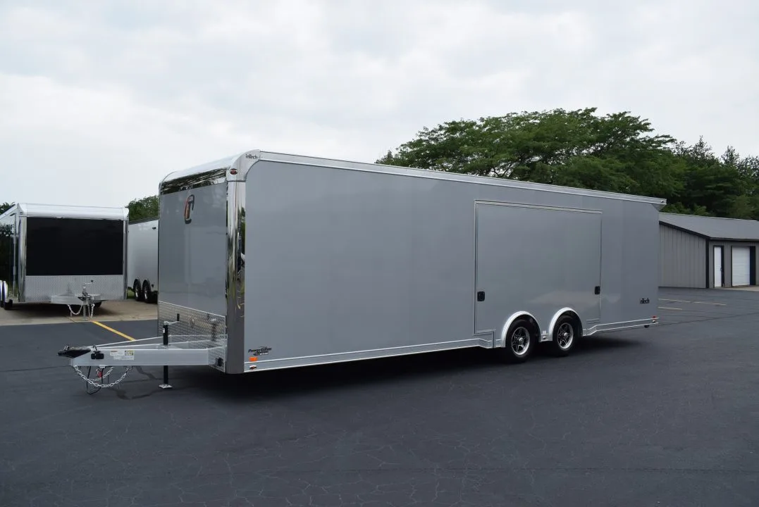 BLOGBANNER (1) The body of a trailer with living quarters parked at the sales lot. The trailer is long with a hitch at the far left end.