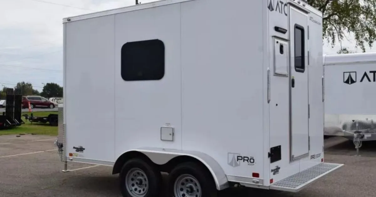 The exterior of a fiber splicing trailer with a small window in the top, lefthand corner. There's an exit door at the back.