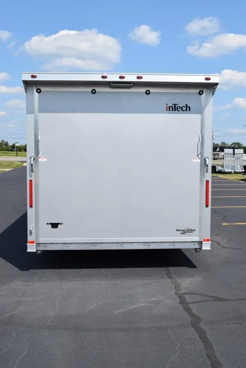 The back exterior of a trailer with living quarters. The end is a door that opens all the way to the ground.