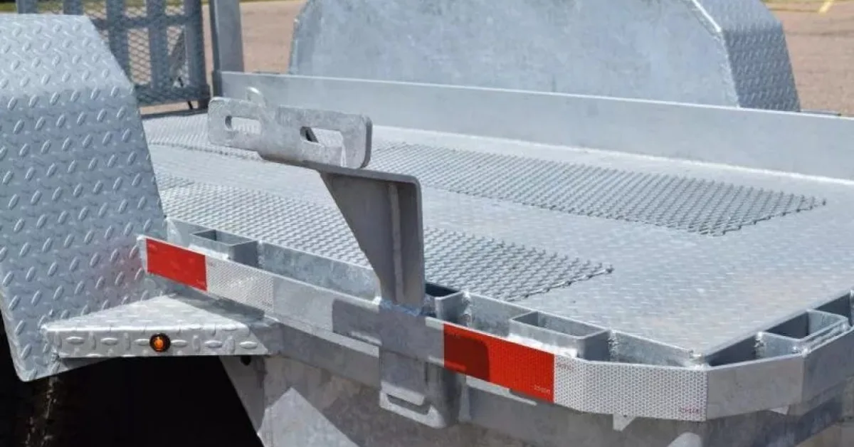 A close-up of a scissor lift trailer made of galvanized steel. There is a hook for a tie-down setup.